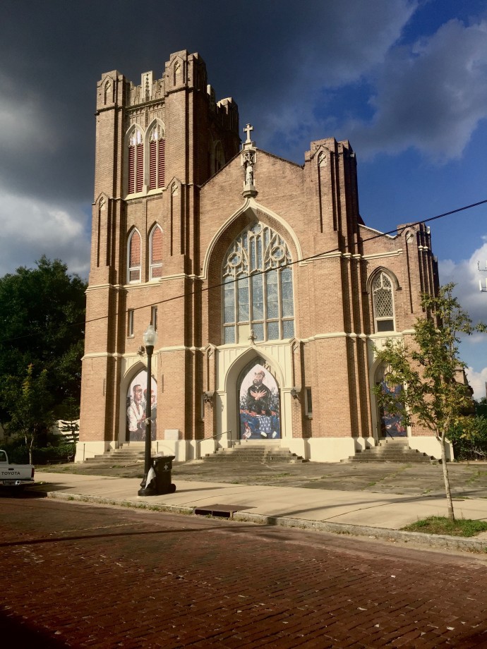 Photo by Nikki Silva. Mural by Langston Allston, André Cailloux & Fr. Maistre: The Life, Death of a Black Patriot, 2017, on the former St. Rose De Lima Church, 2541 Bayou Road, produced in partnership with Broad Community Connections.