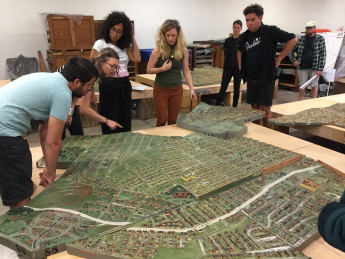 Stella Lochman (center) and volunteers cleaning the model.